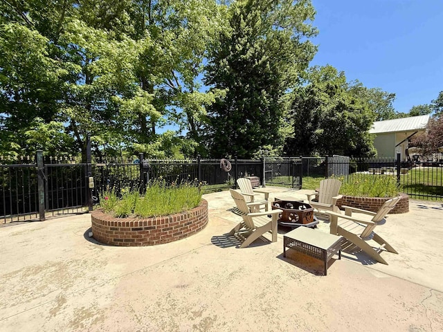 view of patio / terrace featuring an outdoor fire pit and fence