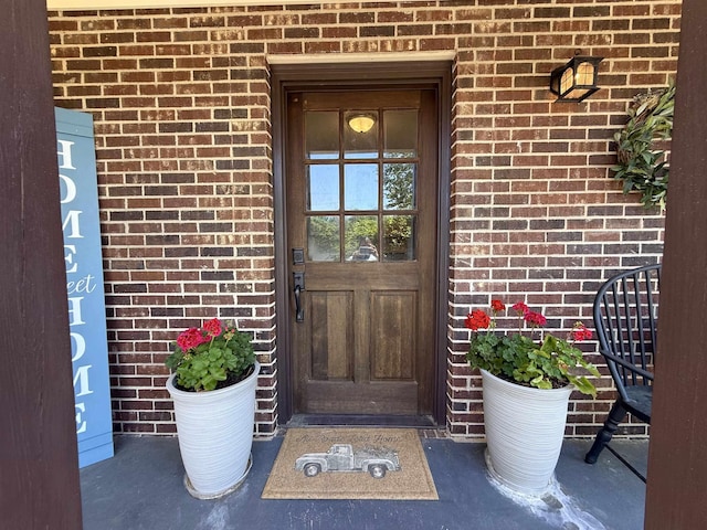 view of exterior entry with brick siding