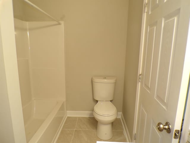 full bathroom featuring tile patterned floors, baseboards, toilet, and shower / tub combination