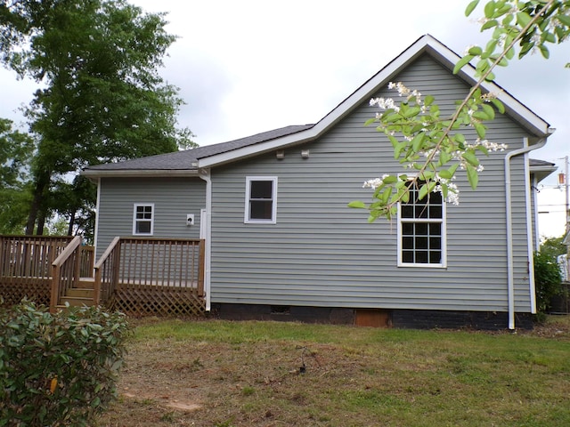 back of property featuring a wooden deck and crawl space