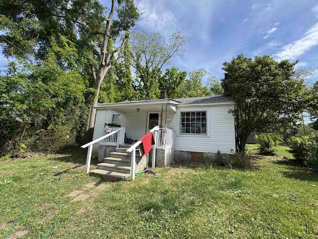 view of front facade featuring a chimney, crawl space, and a front yard