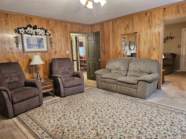living room featuring carpet flooring, a textured ceiling, and wood walls