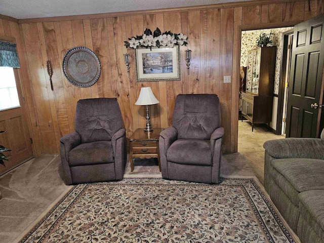 living room featuring carpet floors, wooden walls, and ornamental molding