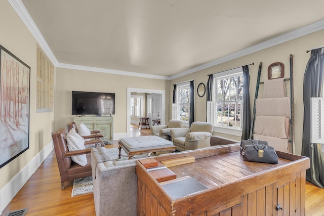 living area with crown molding and light wood-style flooring