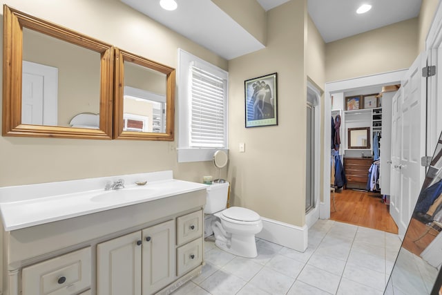 bathroom with tile patterned flooring, vanity, toilet, recessed lighting, and a shower stall