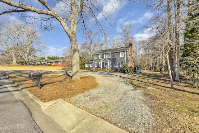 colonial-style house featuring a chimney