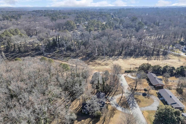 drone / aerial view featuring a forest view