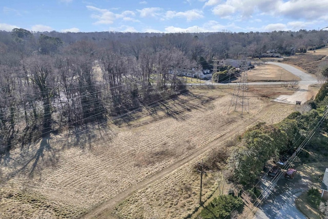 birds eye view of property featuring a wooded view