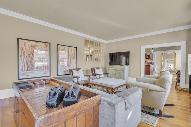 living area featuring crown molding, light wood-style floors, and baseboards