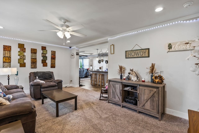 carpeted living room featuring baseboards, ceiling fan, and recessed lighting