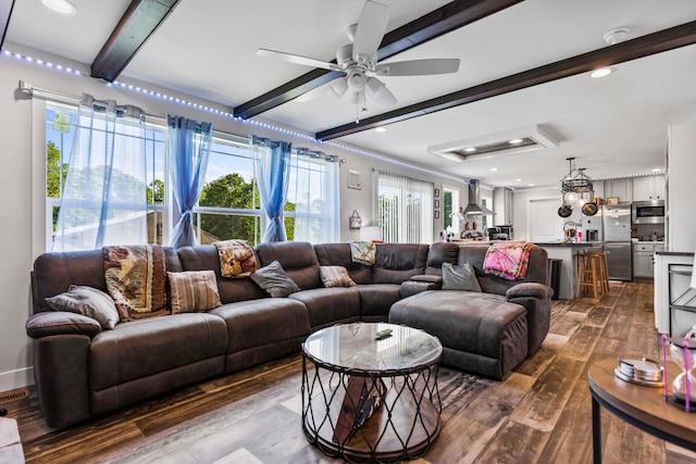 living room featuring dark wood-style flooring, ceiling fan, and beam ceiling