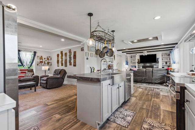 kitchen with recessed lighting, open floor plan, a sink, and dark wood-style floors