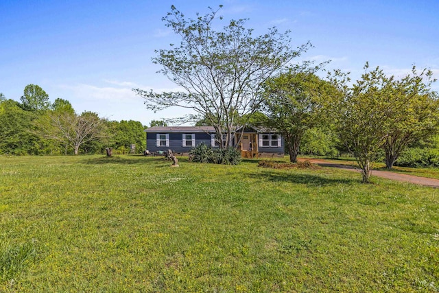 view of front of house with driveway and a front yard