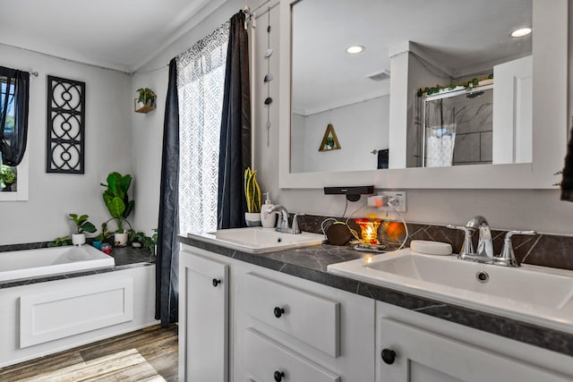 full bath featuring a sink, a stall shower, and a healthy amount of sunlight