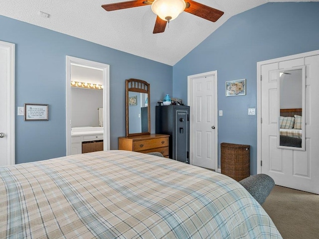 carpeted bedroom with ensuite bathroom, a ceiling fan, and vaulted ceiling