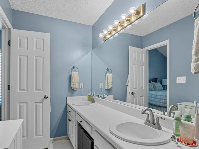 full bathroom featuring double vanity, a sink, and a textured ceiling