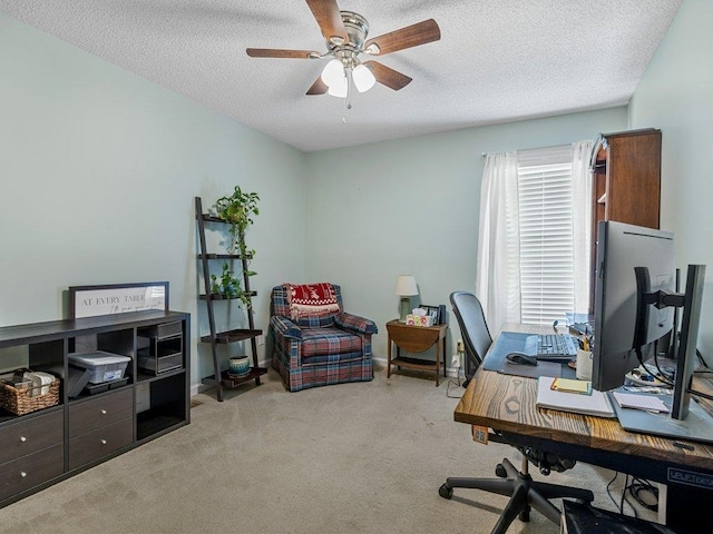 home office featuring carpet flooring, a textured ceiling, and ceiling fan