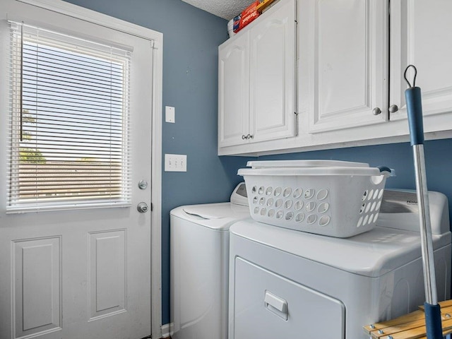 washroom featuring cabinet space and independent washer and dryer