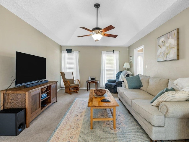 living area with light carpet and a ceiling fan