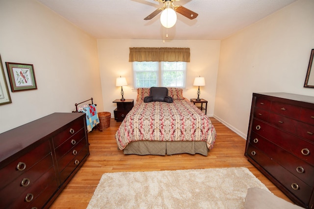 bedroom with a ceiling fan and light wood finished floors