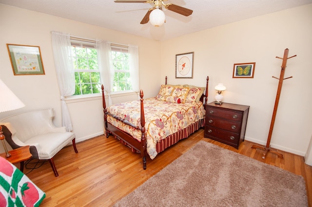 bedroom with baseboards, a ceiling fan, and wood finished floors