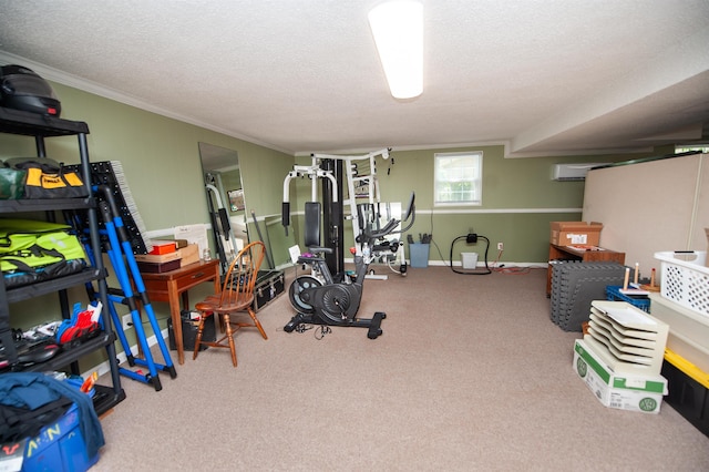 workout area featuring carpet floors, a textured ceiling, and ornamental molding