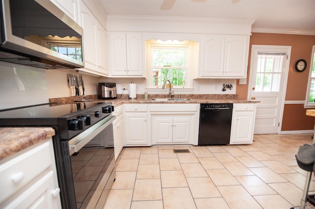 kitchen featuring crown molding, electric range oven, stainless steel microwave, a sink, and dishwasher