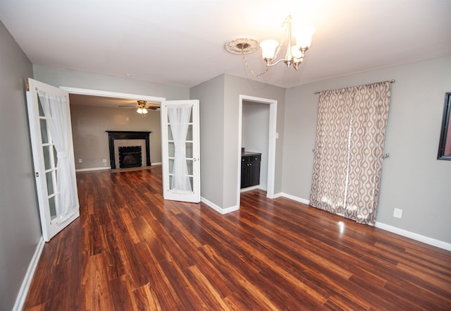 interior space featuring baseboards, a fireplace, and wood finished floors