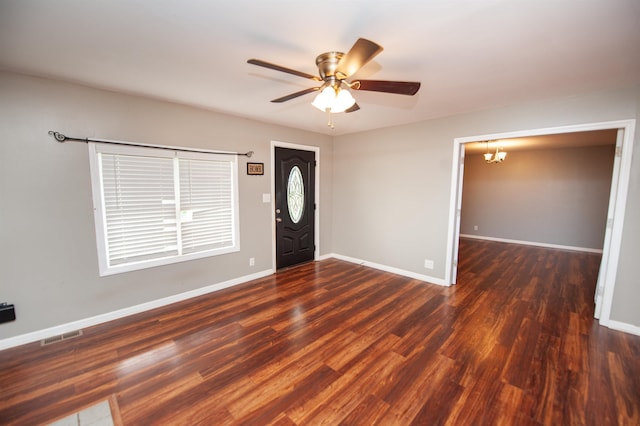 foyer with baseboards, visible vents, wood finished floors, and ceiling fan with notable chandelier