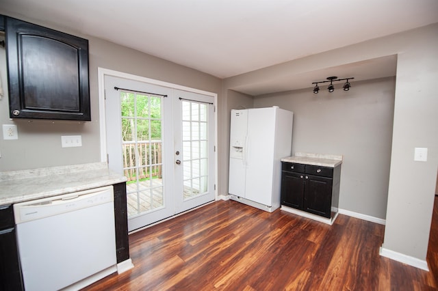 doorway featuring baseboards, dark wood finished floors, and french doors