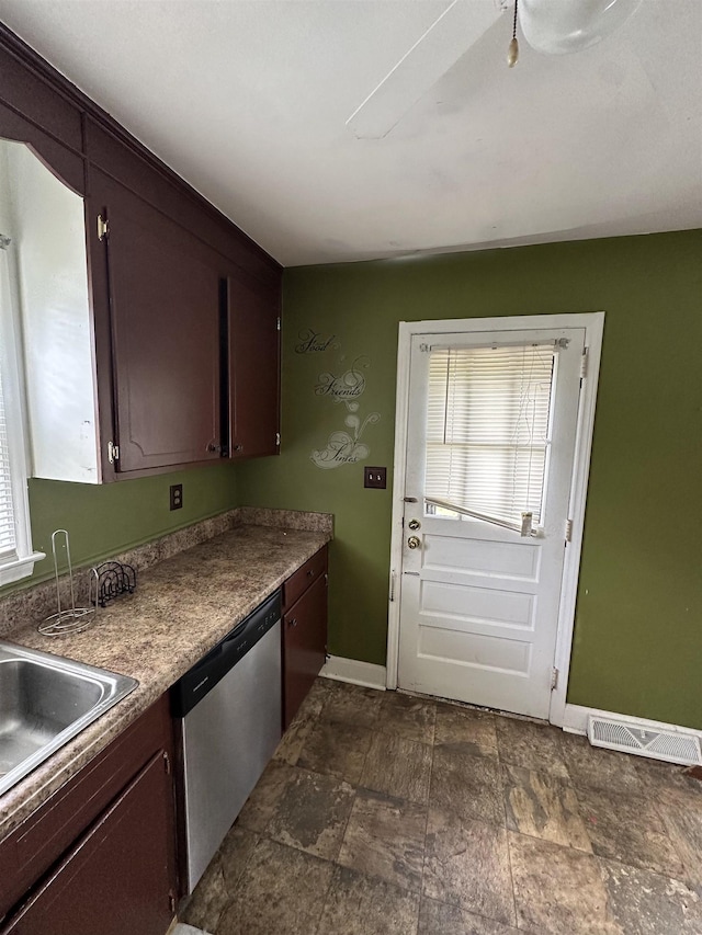 kitchen featuring baseboards, visible vents, stainless steel dishwasher, and a wealth of natural light