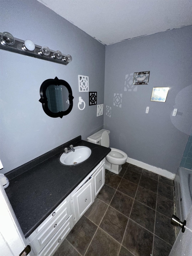 bathroom with vanity, tile patterned flooring, and toilet
