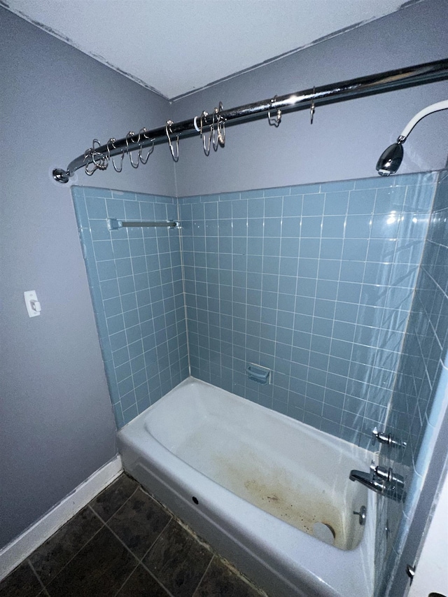 full bath featuring tile patterned flooring,  shower combination, and baseboards