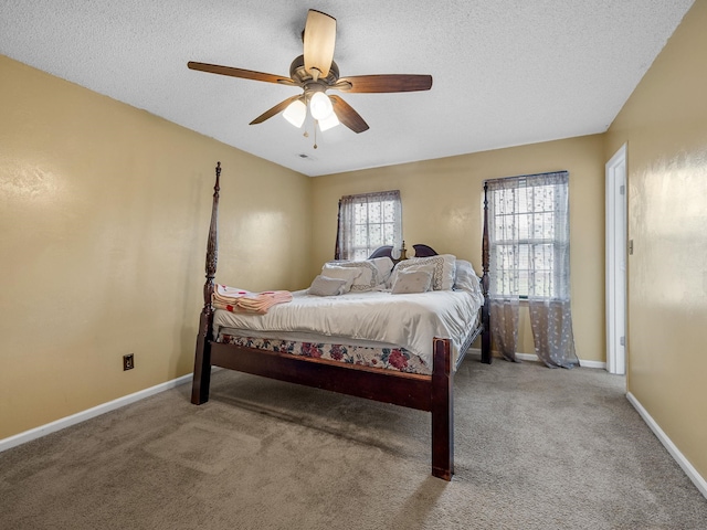 bedroom featuring carpet floors, a textured ceiling, baseboards, and ceiling fan