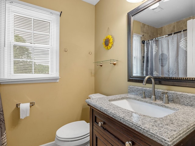 bathroom with visible vents, a shower with shower curtain, toilet, and vanity