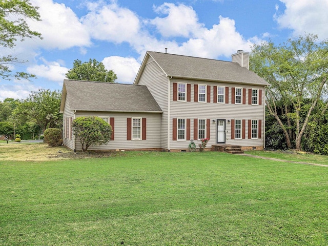 colonial inspired home with a chimney, roof with shingles, and a front lawn