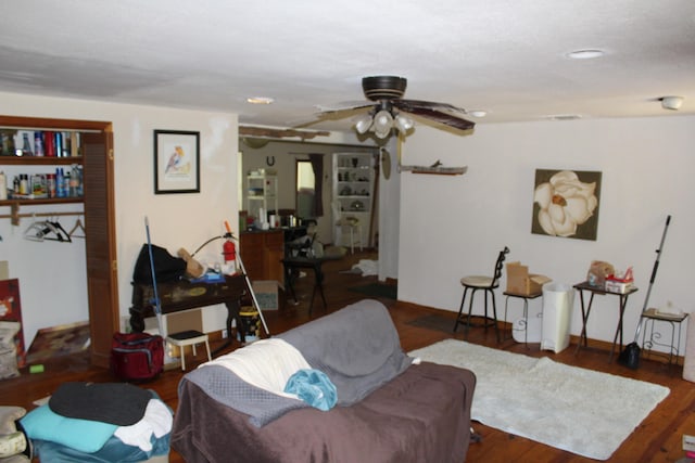living room with a ceiling fan and wood finished floors