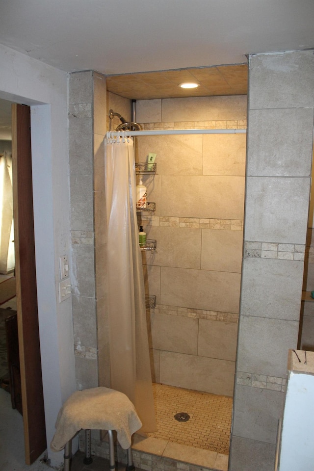 bathroom with tiled shower