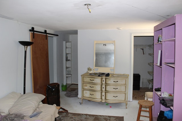 bedroom featuring a closet, a barn door, and a spacious closet