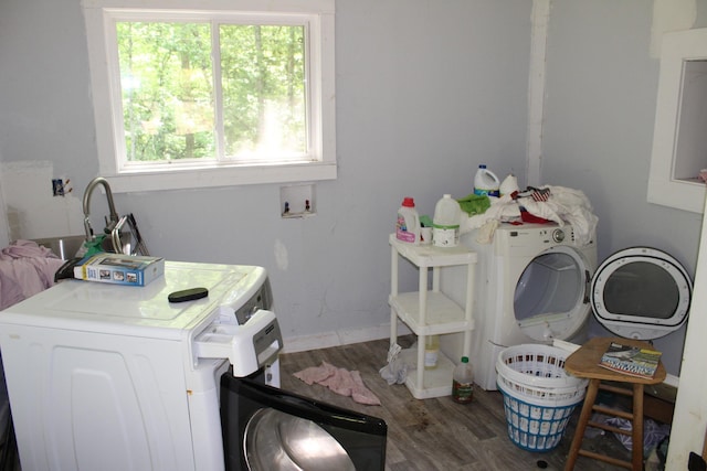 laundry room featuring baseboards, laundry area, washer / dryer, and wood finished floors