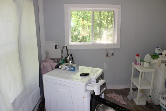 washroom with laundry area, washer / dryer, wood finished floors, baseboards, and a sink