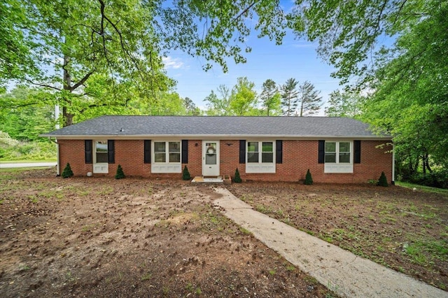 ranch-style home featuring brick siding