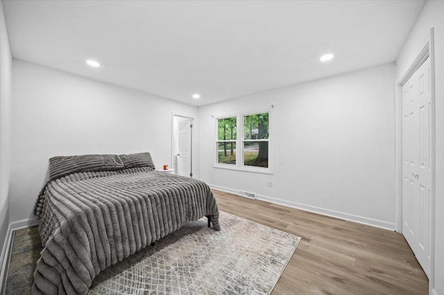 bedroom featuring recessed lighting, baseboards, visible vents, and wood finished floors