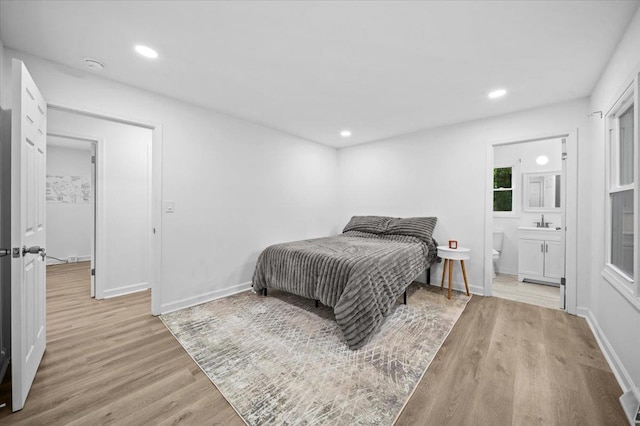 bedroom with visible vents, baseboards, recessed lighting, connected bathroom, and light wood finished floors