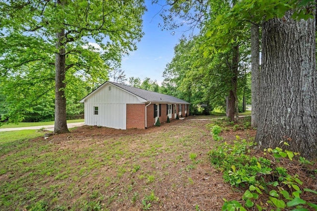exterior space featuring board and batten siding and brick siding