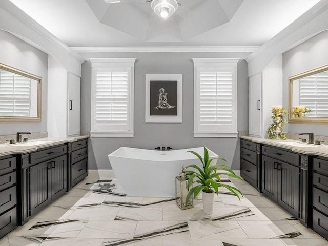 full bath featuring ceiling fan, ornamental molding, and a sink
