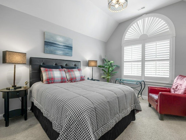 carpeted bedroom with baseboards, multiple windows, vaulted ceiling, and visible vents