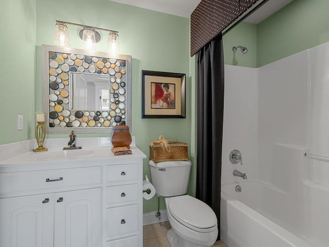 bathroom with vanity, toilet, tile patterned floors, baseboards, and shower / tub combo