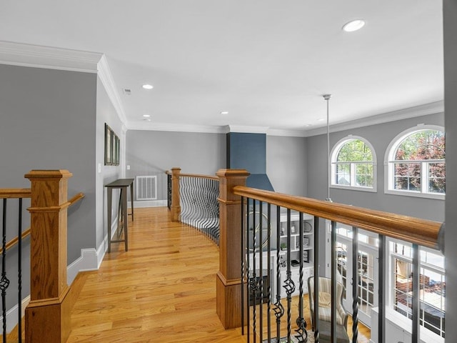 corridor featuring recessed lighting, light wood-style flooring, visible vents, and an upstairs landing