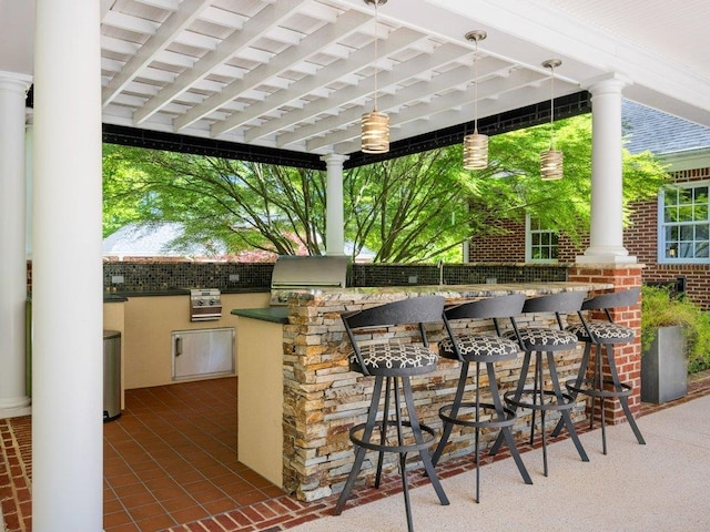 view of patio / terrace featuring an outdoor kitchen, outdoor wet bar, and a grill